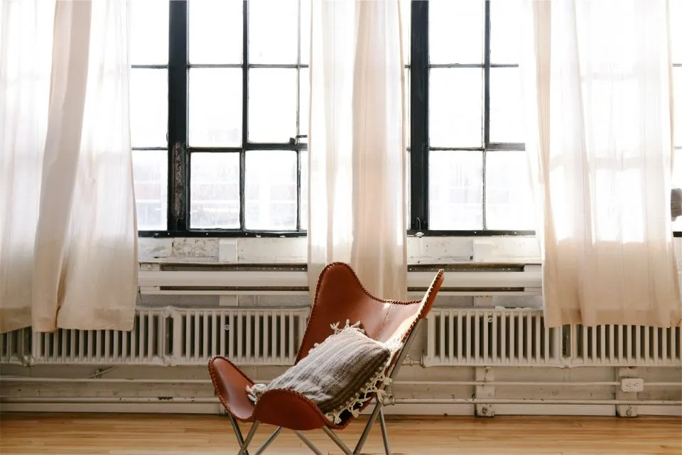 Bright room with a radiator running beneath tall windows